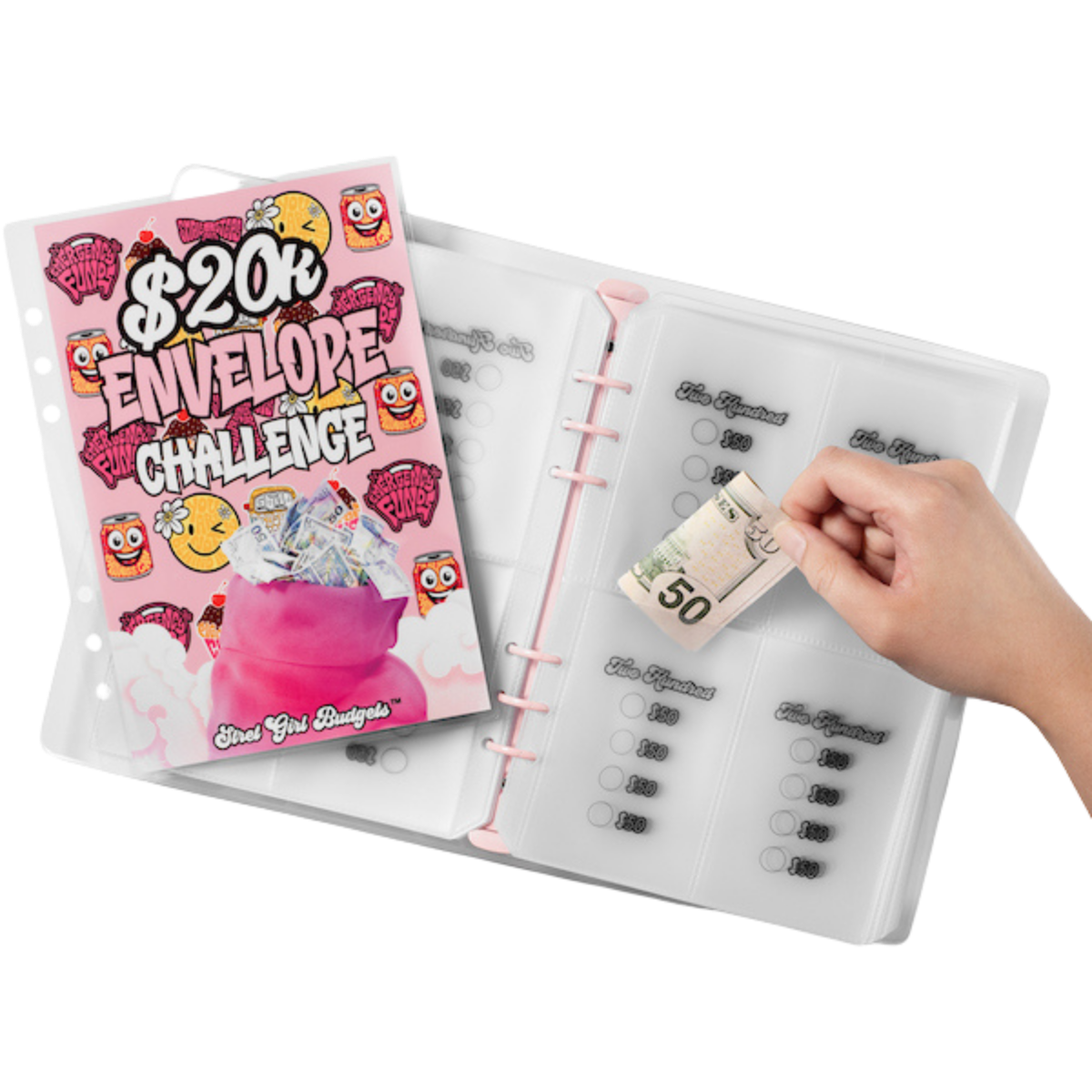Money envelope system with a pink book titled '$20k Envelope Challenge' and a hand placing money into it.