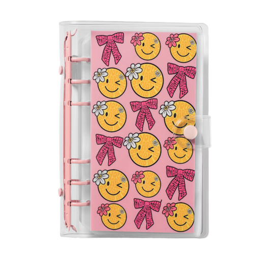 Planner cover with smiley face design on a pink background